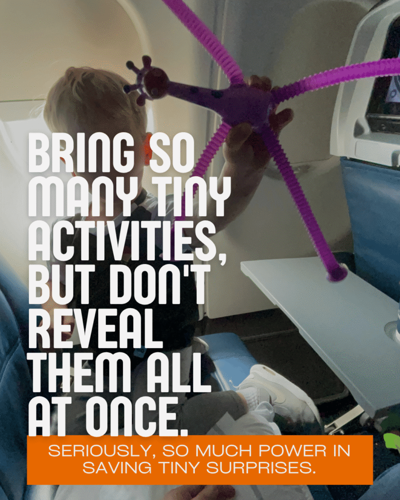 Toddler playing with purple suction fidget toy on airplane tray table, bring tiny activities for toddlers on flights but don’t reveal all at once