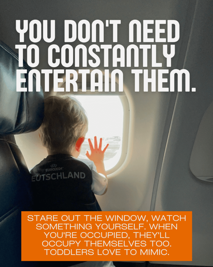 Toddler in airplane window seat looking outside, letting toddlers zone out and self-entertain on flights