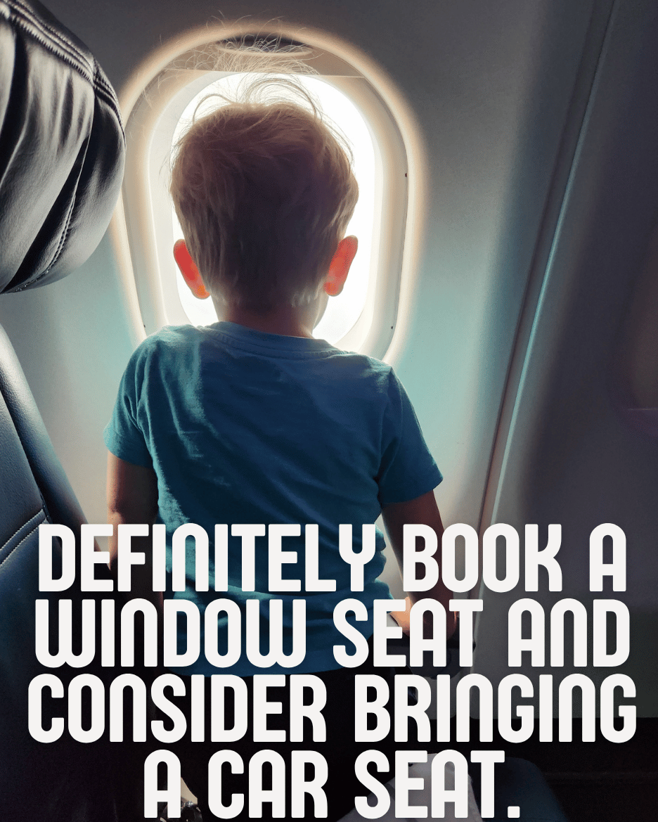 Toddler looking out the window Definitely book a window seat and consider booking a car seat.