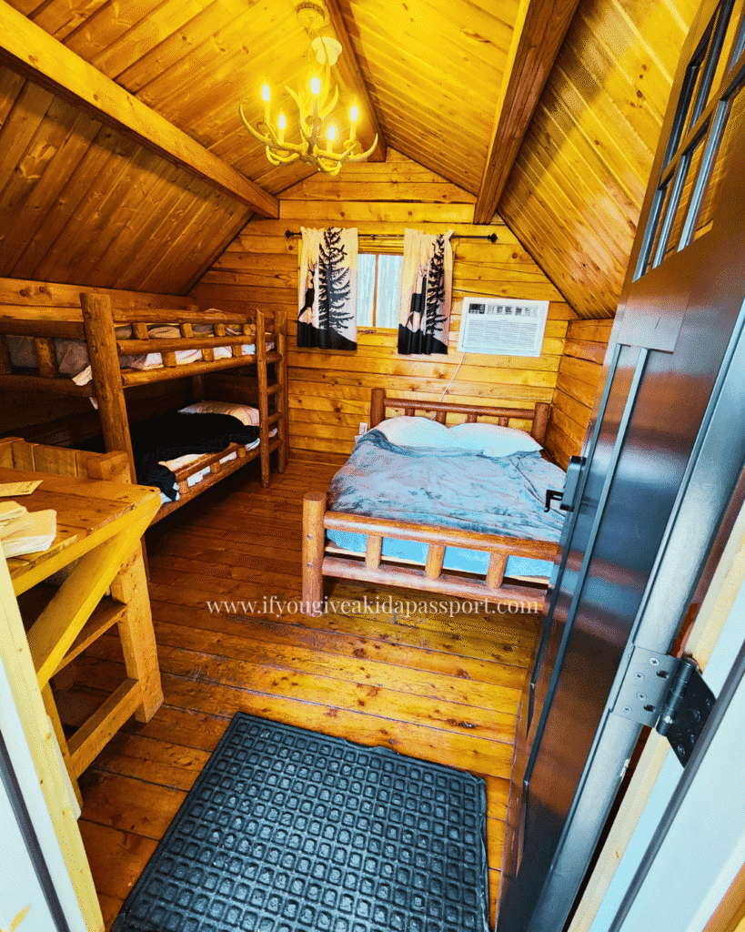 View inside the West Glacier KOA Resort 4-person Comfort Camping Cabin, Patio Single Room, no bathroom. The Comfort part meant AC, which was clutch in July, and linens were included (we made the bed ourselves).